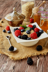 oatmeal with berries on a wooden table, selective focus