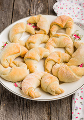 Fresh yeast croissants with marmalade on plate
