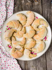 Fresh yeast croissants with marmalade on plate