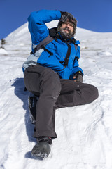 Fototapeta na wymiar Bearded trekker resting while climbing