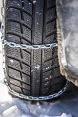 Closeup of car with mounted snow chains