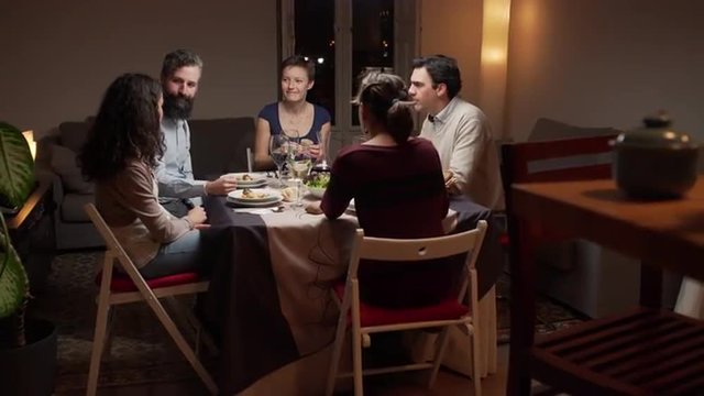 Group of young people dinning together. The camera moves. 4K, UHD