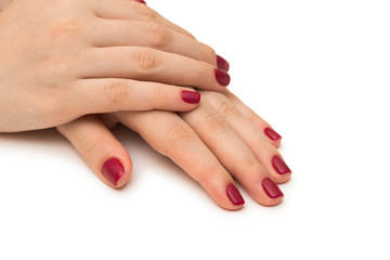 Fototapeta premium Woman hands with red nail isolated on white