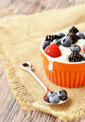 oatmeal with berries on a wooden table, selective focus