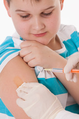 Doctor giving a child injection in arm on isolated image.