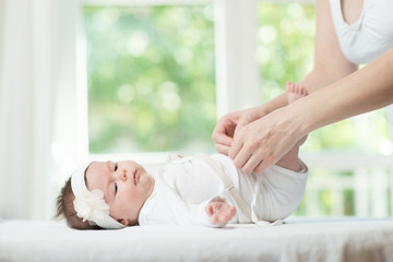 Mother changes her babies nappy