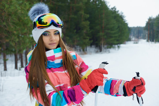 A skiing girl in bright sport clothes