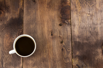 White cup of coffee wooden backgroun