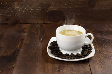 white Cup Coffee whit milk and beans on a wooden background