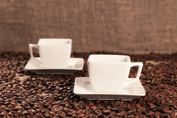 Cups with coffee and coffee beans