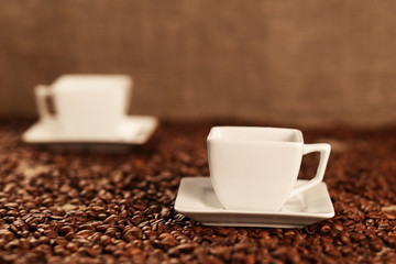 Cups with coffee and coffee beans
