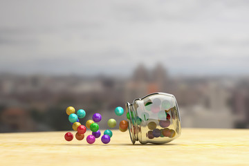 Colorful candies scattering out of glass jar