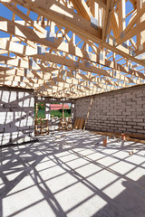 New residential wooden construction home framing. Building a roof with wooden balks