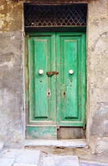 Green door on an old stone building in Malta