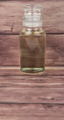 Obraz na płótnie Canvas Corn vegetable cooking oil in vial glass over wooden background