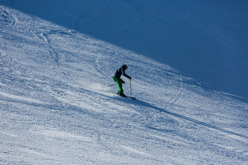 Fototapeta na wymiar Skiers sliding from mountains