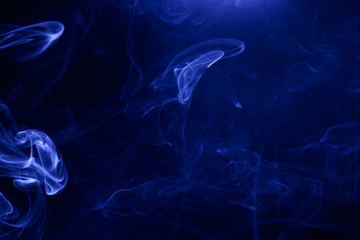Blue smoke on a black background.