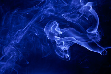 Fototapeta premium Blue smoke on a black background.