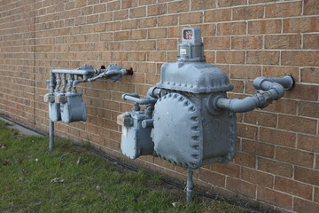 Natural Gas Supply Regulator Meter on Brick Wall Building