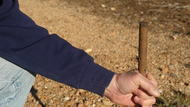 Man pounding in a steel stake