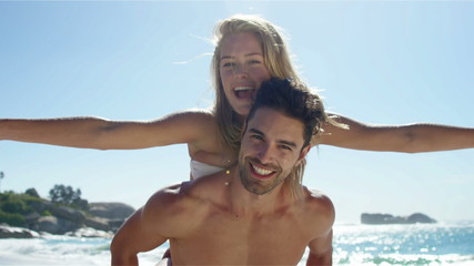 Boyfriend giving piggy back to girlfriend - Powered by Adobe