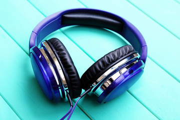 Headphones on wooden background