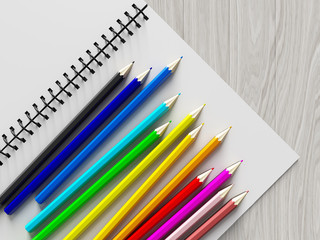 Obraz premium color pencil on checked notebook on wood background