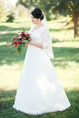 Bride on a background of trees, Fine portrait, full-length. 