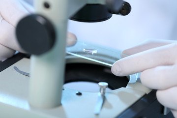 Serious clinician studying chemical element in laboratory