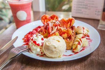 Close up of vanilla ice cream with Strawberry toast, ice cream sherbet and banana.