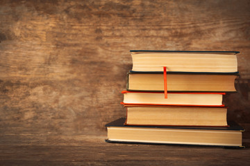 Pile of books on wooden background