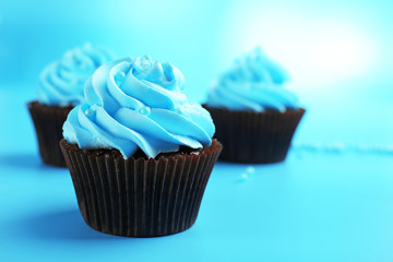 Chocolate cupcakes on blue background