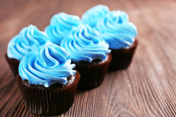 Chocolate cupcakes on wooden background