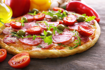 Delicious tasty pizza with ingredients on table, closeup