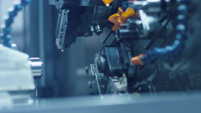 CNC milling machine is working and producing a metal detail. Shot on RED Cinema Camera.
