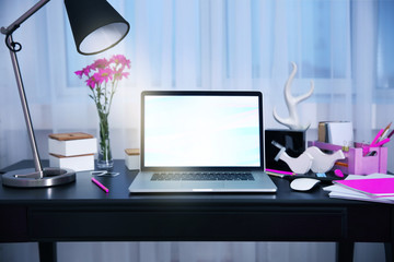 Workplace with laptop on table at home