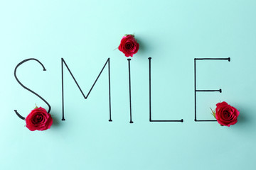 Inscription smile with pink roses on green background