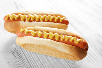 Two hot dogs on wooden background