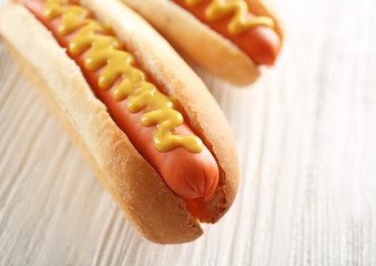 Two hot dogs on wooden background