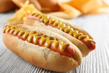 Hot dogs with cheese on wooden background