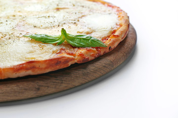 Pizza full of cheese on wooden board isolated on white background, close up