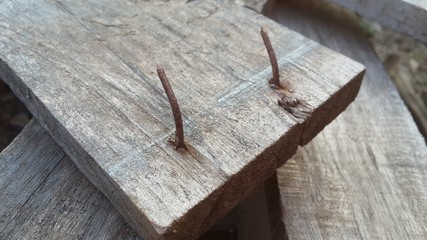 Rusty nail in obsolete wood plank