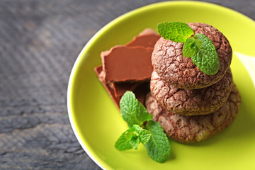 Chocolate chip cookie with yellow stripe and mint in plate, closeup