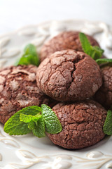 Chocolate chip cookie with mint in plate, closeup