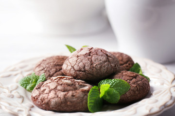 Chocolate chip cookie with mint on light background