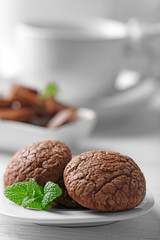 Chocolate chip cookie in plate with mint, closeup