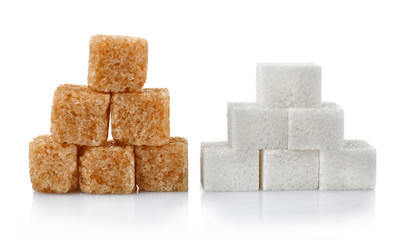 Pile of brown and white sugar cubes isolated on white background