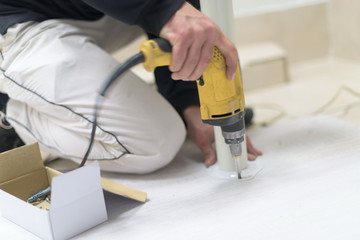 repairman working with drilling machine