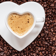 white coffee cup heart shaped with cappucino