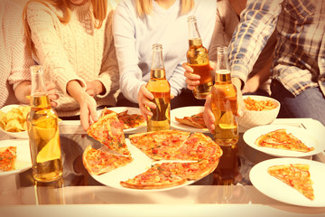 Friendly party with hot pizza and drinks, close up